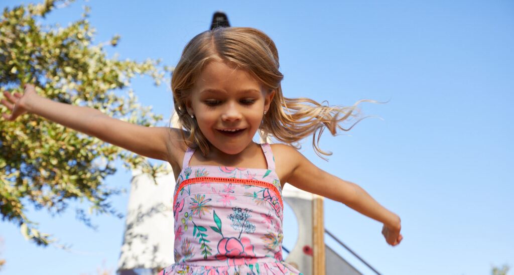 Child jumping for joy in the Alamar community in Avondale, Arizona