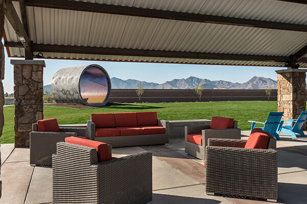 Starlight Pass Park seating area with view of art structure at Alamar community in Avondale, Arizona