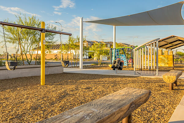 Drift Way Park playground swings at Alamar community in Avondale, AZ